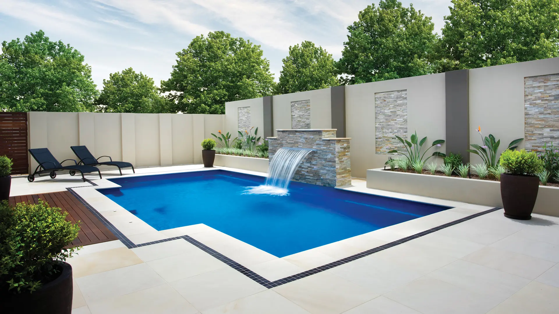 Leisure Pools Limitless rectangular fiberglass swimming pool with built-in spa and splash deck