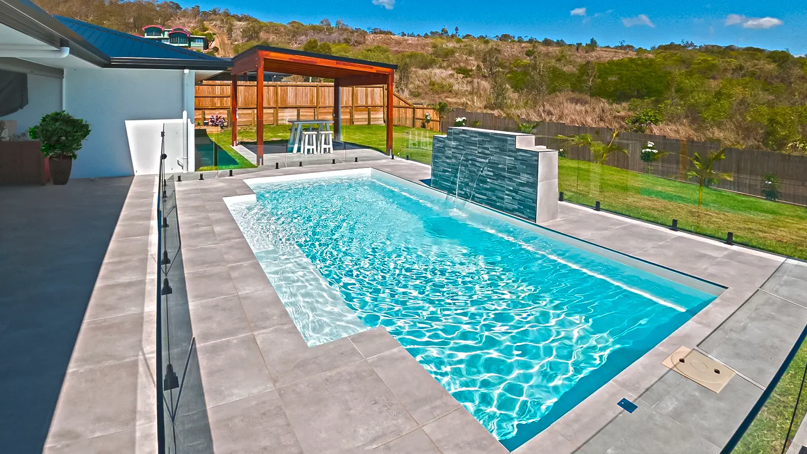 Leisure-Pools-shimmer-sky-pool-color-hero-image A Leisure Pools inground swimming pool in Shimmer Sky color