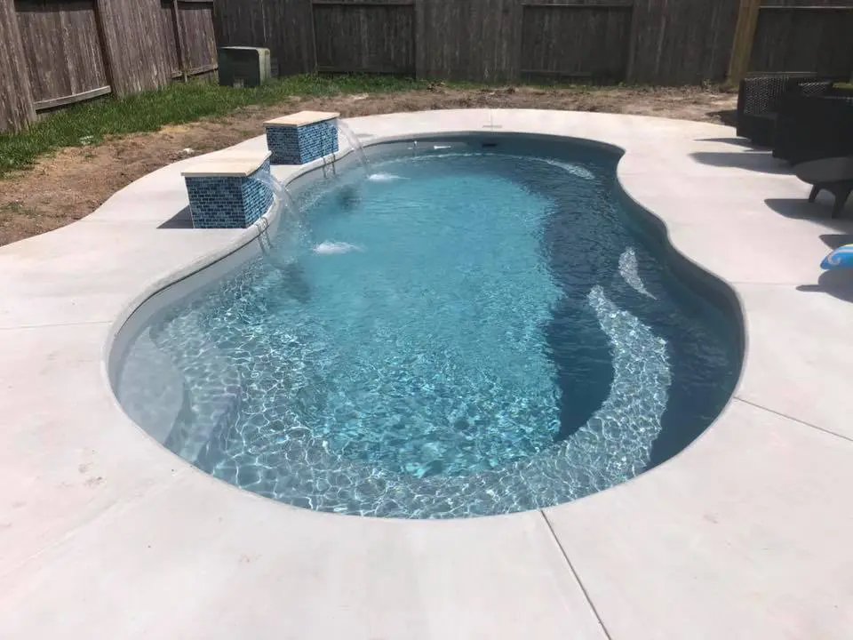 An inground, free form fiberglass pool, built by Leisure Pools San Antonio, premier pool builder for San Antonio, Texas